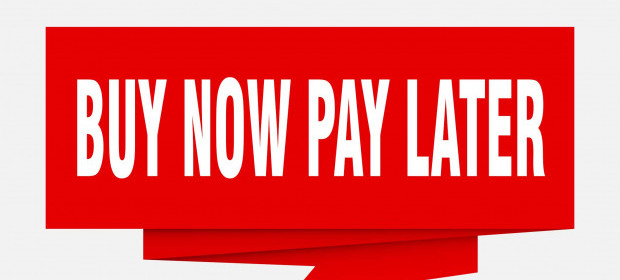 The words BUY NOW PAY LATER shown on a vibrant red banner