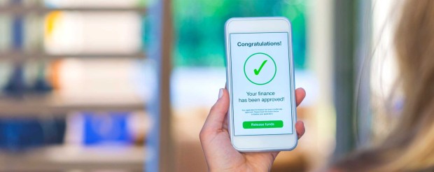 A woman receiving a finance approval notification on her phone