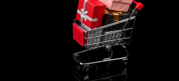 A shopping trolly with wrapped presents inside